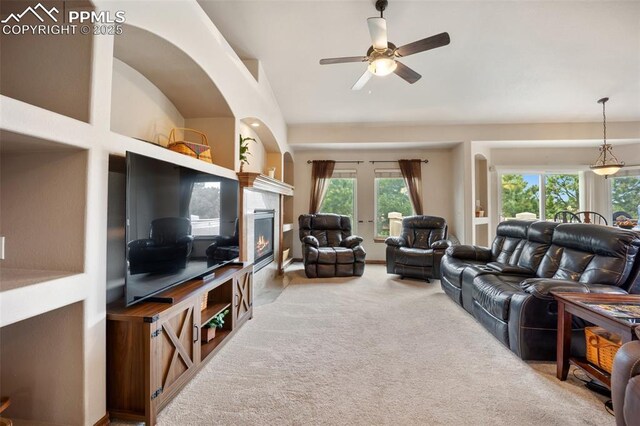 20280 Melanie Ann Ct, Monument, CO 80132 - carpeted living room with a ceiling fan, lofted ceiling, and a glass covered fireplace