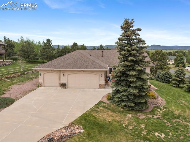 20280 Melanie Ann Ct, Monument, CO 80132 - view of front of property featuring stucco siding, a garage, driveway, stone siding, and a mountain view