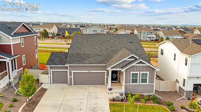 13138 Stoney Meadows Way, Peyton, CO 80831 - view of front of property with board and batten siding, a residential view, an attached garage, and concrete driveway