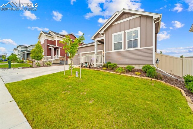 13138 Stoney Meadows Way, Peyton, CO 80831 - view of front of property with board and batten siding, concrete driveway, and a garage