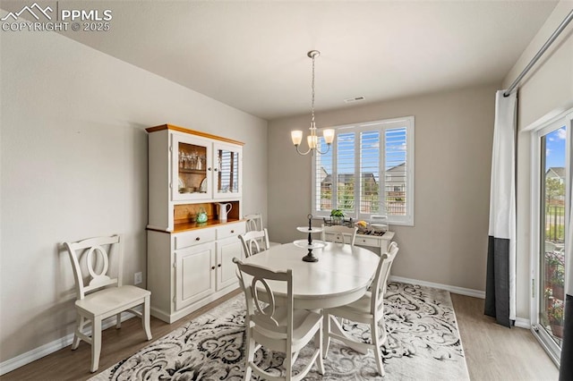 13138 Stoney Meadows Way, Peyton, CO 80831 - dining room featuring light wood-style floors, a chandelier, and baseboards