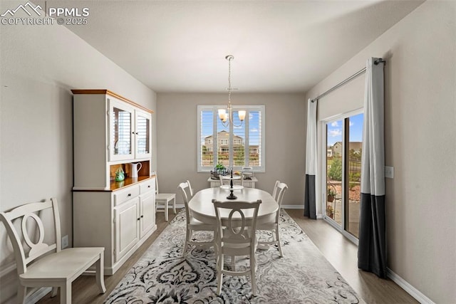 13138 Stoney Meadows Way, Peyton, CO 80831 - dining room featuring a chandelier, light wood-type flooring, and baseboards