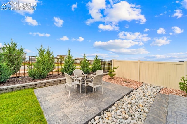 13138 Stoney Meadows Way, Peyton, CO 80831 - fenced backyard featuring a patio and outdoor dining area