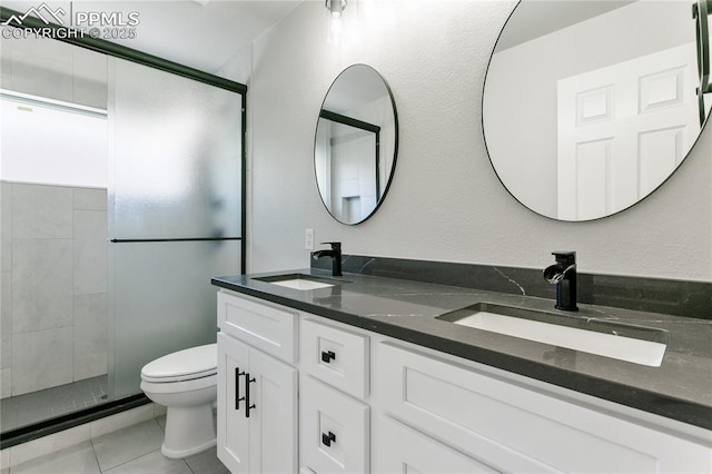 531 Saber Creek Dr, Monument, CO 80132 - bathroom with toilet, double vanity, tiled shower, and tile patterned floors