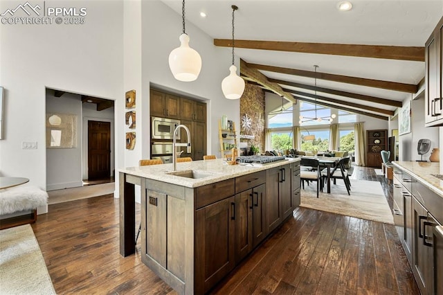 3320 Camels Ridge Ln, Colorado Springs, CO 80904 - kitchen featuring stainless steel microwave, dark wood-type flooring, high vaulted ceiling, beam ceiling, and light stone counters