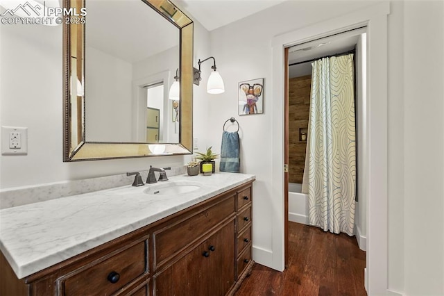 3320 Camels Ridge Ln, Colorado Springs, CO 80904 - bathroom with vanity, wood finished floors, and shower / bath combo