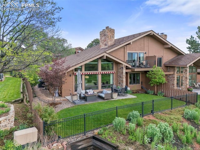 3320 Camels Ridge Ln, Colorado Springs, CO 80904 - back of property with a chimney, an outdoor hangout area, a fenced backyard, a balcony, and a patio