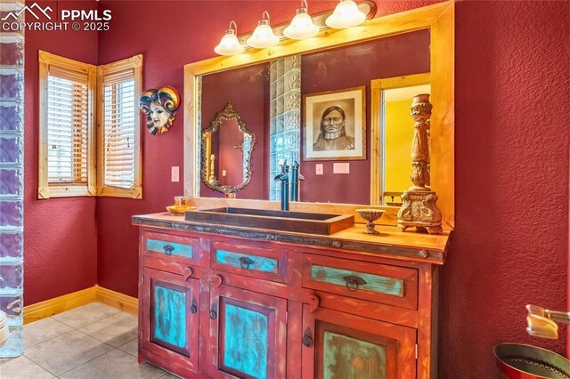 15958 Shadow Mountain Ranch Rd, Larkspur, CO 80118 - bathroom featuring tile patterned floors, vanity, a textured wall, and baseboards