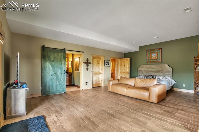15958 Shadow Mountain Ranch Rd, Larkspur, CO 80118 - living room featuring a barn door, baseboards, and wood finished floors