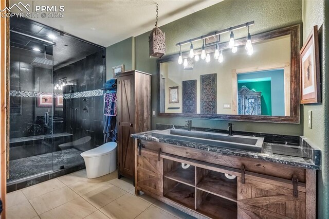 15958 Shadow Mountain Ranch Rd, Larkspur, CO 80118 - full bath featuring a stall shower, toilet, double vanity, tile patterned flooring, and a textured wall
