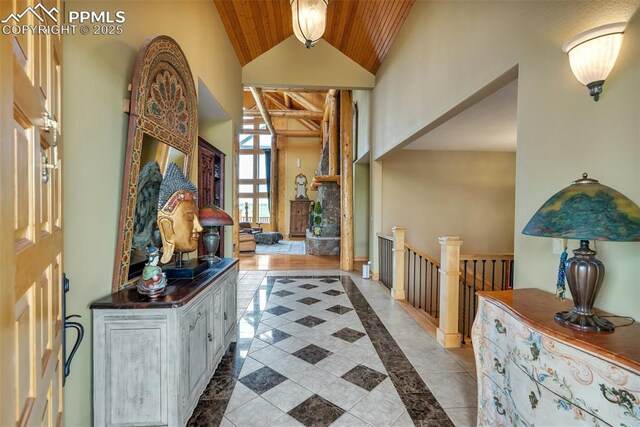 15958 Shadow Mountain Ranch Rd, Larkspur, CO 80118 - foyer entrance with wood ceiling, high vaulted ceiling, inlaid floor details, and tile patterned flooring
