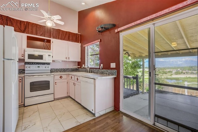 6430 Chantilly Pl, Colorado Springs, CO 80922 - kitchen featuring white appliances, white cabinetry, a ceiling fan, and light marble finish floors
