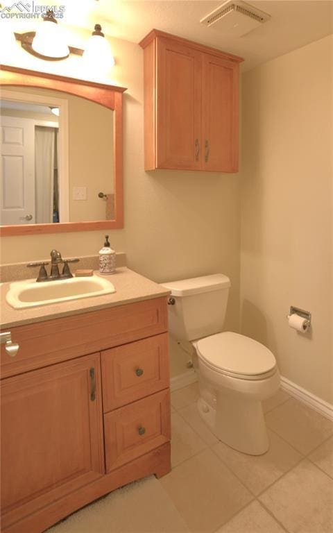 2525 Snowbird Ct, Colorado Springs, CO 80918 - half bathroom featuring baseboards, toilet, tile patterned floors, and vanity
