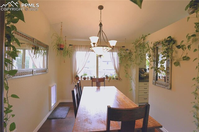 2525 Snowbird Ct, Colorado Springs, CO 80918 - dining area featuring baseboards, a chandelier, and dark wood finished floors