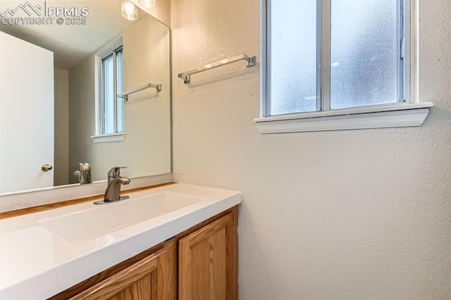 9412 Dew Drop Ct, Colorado Springs, CO 80925 - bathroom with vanity and a textured wall