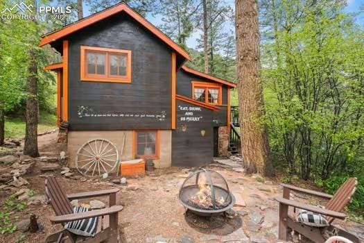 6015 Sioux Trl, Cascade, CO 80809 - view of outbuilding featuring a fire pit