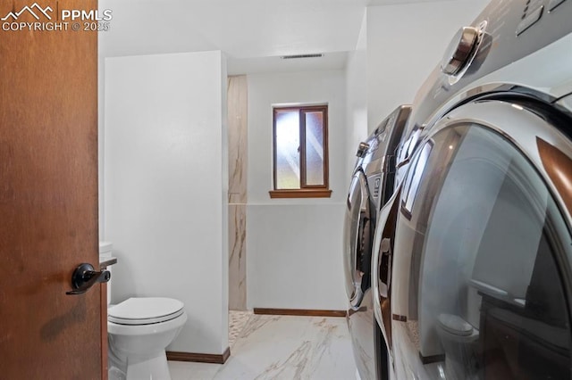 527 W Columbia St, Colorado Springs, CO 80907 - laundry area with washer and clothes dryer, light marble finish floors, and baseboards