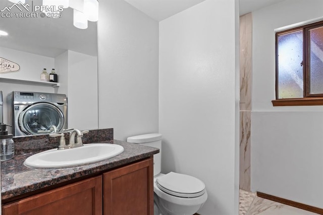 527 W Columbia St, Colorado Springs, CO 80907 - bathroom with washer / dryer, walk in shower, toilet, vanity, and marble finish floors