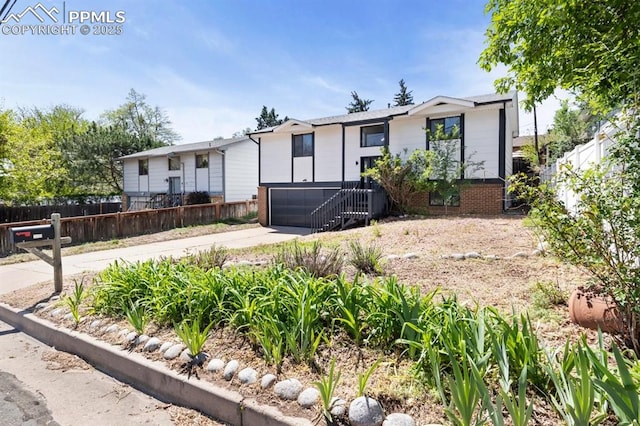 527 W Columbia St, Colorado Springs, CO 80907 - view of front of home with concrete driveway, brick siding, and an attached garage