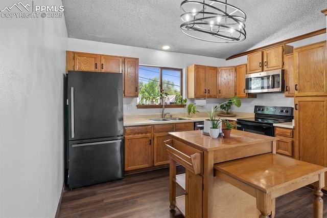 527 W Columbia St, Colorado Springs, CO 80907 - kitchen featuring freestanding refrigerator, black range with electric stovetop, stainless steel microwave, a sink, and a textured ceiling
