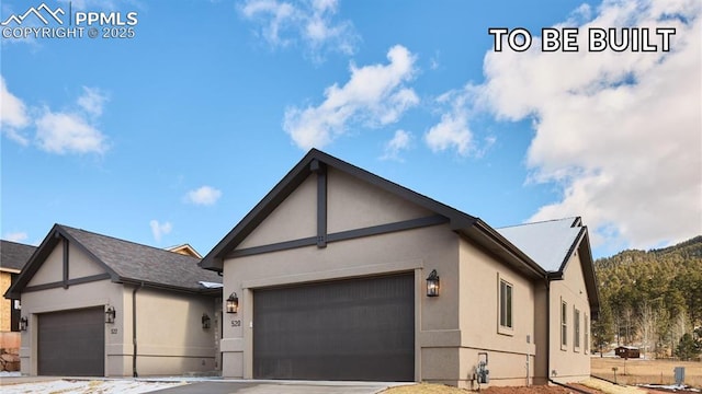529 Brecken Ct Unit A, Woodland Park, CO 80863 - view of front facade with stucco siding, a garage, and driveway