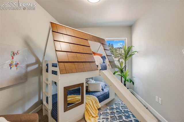 529 Brecken Ct Unit A, Woodland Park, CO 80863 - carpeted bedroom with vaulted ceiling and baseboards