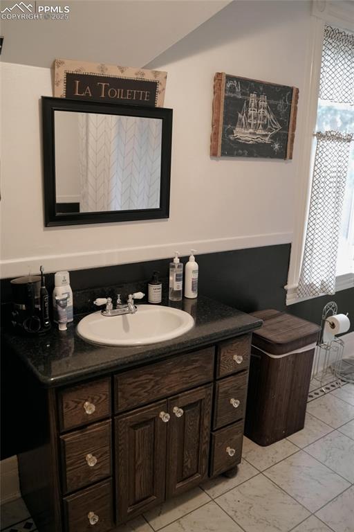 817 Swope Ave, Colorado Springs, CO 80909 - bathroom featuring vanity and marble look tiles