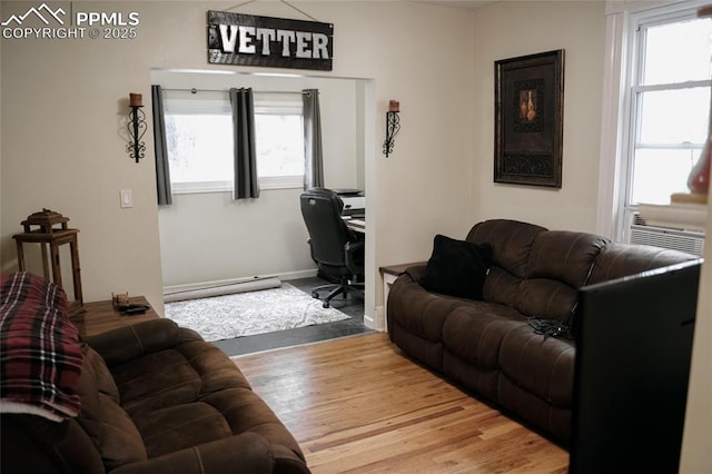 817 Swope Ave, Colorado Springs, CO 80909 - living area with wood finished floors, an office area, and a baseboard heating unit