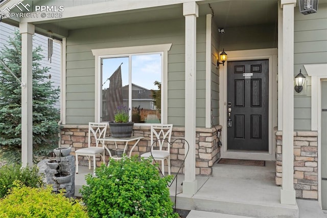 10067 Seawolf Dr, Colorado Springs, CO 80925 - property entrance featuring a porch and stone siding
