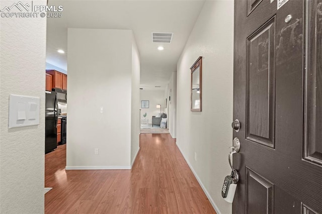 10067 Seawolf Dr, Colorado Springs, CO 80925 - hallway featuring light wood-type flooring and baseboards