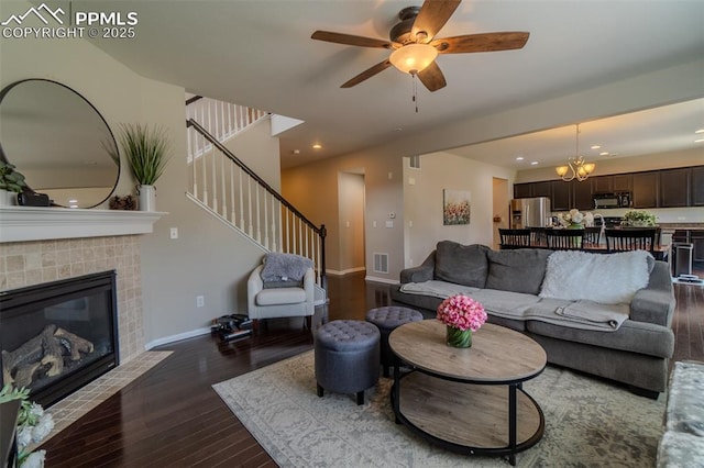 7312 Grady Cir, Castle Rock, CO 80108 - living area with dark wood-type flooring, a ceiling fan, baseboards, stairs, and a tiled fireplace