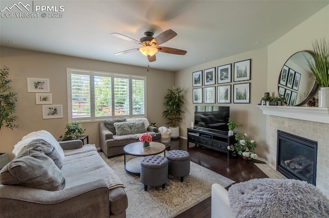 7312 Grady Cir, Castle Rock, CO 80108 - living area featuring a ceiling fan, hardwood / wood-style floors, a tiled fireplace, and baseboards