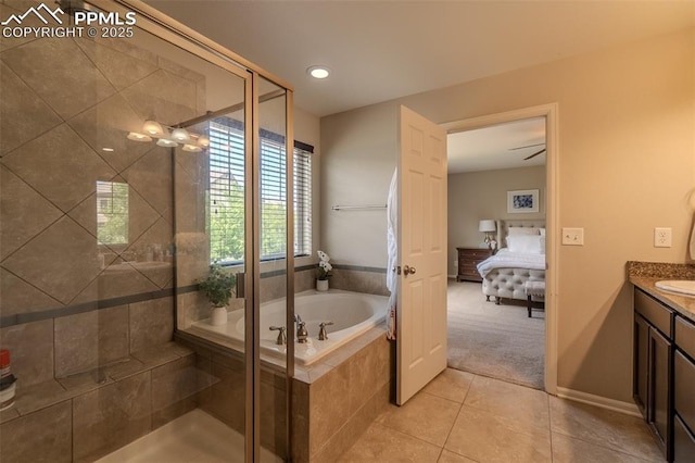 7312 Grady Cir, Castle Rock, CO 80108 - ensuite bathroom featuring vanity, a garden tub, tile patterned floors, and a stall shower