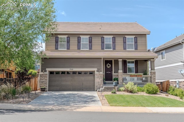 7312 Grady Cir, Castle Rock, CO 80108 - view of front of house with covered porch, a garage, driveway, stone siding, and a tiled roof