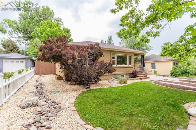 1017 N Sheridan Ave, Colorado Springs, CO 80909 - view of front facade with stucco siding and an outbuilding