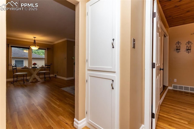 1017 N Sheridan Ave, Colorado Springs, CO 80909 - corridor featuring light wood finished floors, crown molding, and baseboards