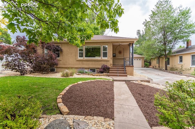 1017 N Sheridan Ave, Colorado Springs, CO 80909 - view of front facade with a front yard, a garage, and stucco siding