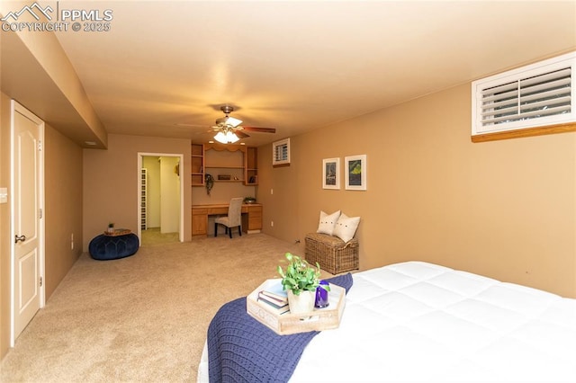 1017 N Sheridan Ave, Colorado Springs, CO 80909 - bedroom featuring an office area, light colored carpet, ceiling fan, and a spacious closet