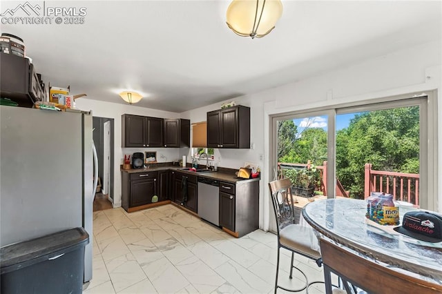 7210 Metropolitan St, Colorado Springs, CO 80911 - kitchen with appliances with stainless steel finishes, light marble finish flooring, dark countertops, a sink, and dark brown cabinetry