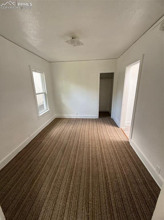 506 S Hancock Ave, Colorado Springs, CO 80903 - spare room featuring carpet flooring, baseboards, and a textured ceiling