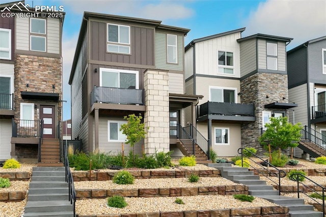6697 Cool Breeze Dr, Colorado Springs, CO 80923 - view of front of house with stairs and board and batten siding
