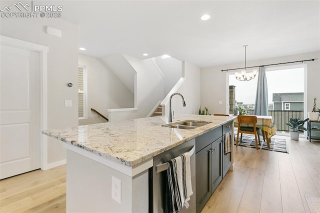 6697 Cool Breeze Dr, Colorado Springs, CO 80923 - kitchen with dishwasher, light wood finished floors, light stone countertops, a chandelier, and pendant lighting