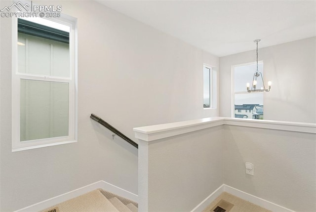 6697 Cool Breeze Dr, Colorado Springs, CO 80923 - stairs featuring baseboards and a chandelier