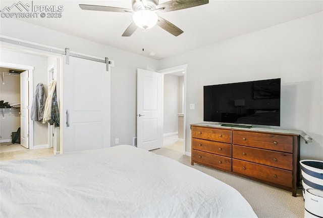 6697 Cool Breeze Dr, Colorado Springs, CO 80923 - bedroom featuring a ceiling fan, a walk in closet, and a barn door