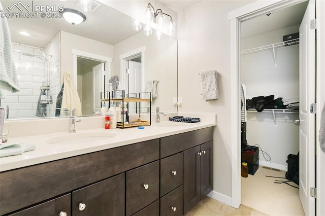 6697 Cool Breeze Dr, Colorado Springs, CO 80923 - full bathroom featuring double vanity, a spacious closet, and a tile shower