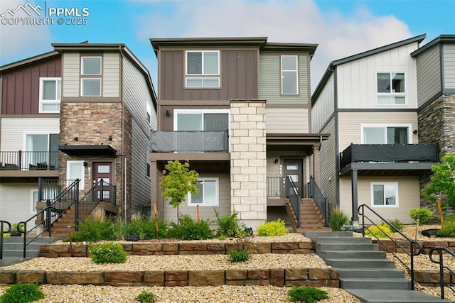 6697 Cool Breeze Dr, Colorado Springs, CO 80923 - view of front facade with board and batten siding, stairway, and stone siding