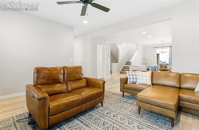 6697 Cool Breeze Dr, Colorado Springs, CO 80923 - living room with stairway, light wood-style floors, ceiling fan, and recessed lighting