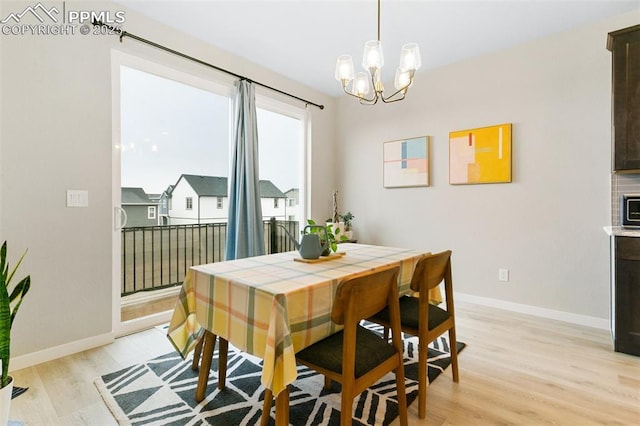 6697 Cool Breeze Dr, Colorado Springs, CO 80923 - dining area featuring light wood finished floors and a chandelier