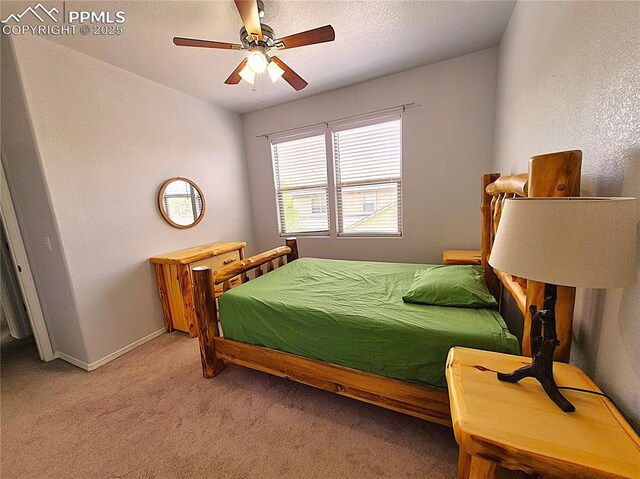 707 Valley View Dr, Woodland Park, CO 80863 - bedroom with light carpet, a ceiling fan, and baseboards