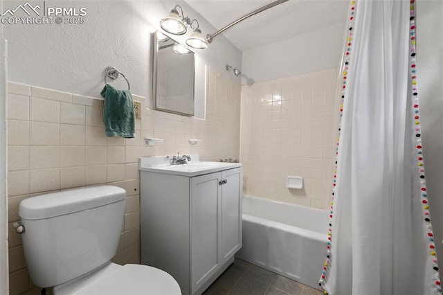 421 N Spruce St, Colorado Springs, CO 80905 - full bathroom with tile walls, toilet, vanity, and shower / bathtub combination with curtain